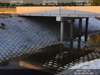 A bridge that is under water and has some waves coming from it.